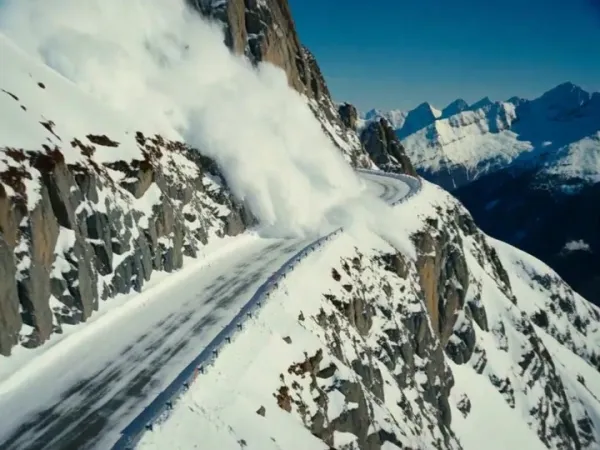 Rally Car Races an Avalanche on an Alpine Cliff Road