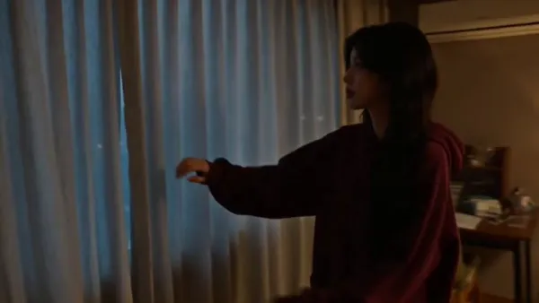 A Young Woman's Quiet Moment in an Old Seoul Apartment on a Rainy Night